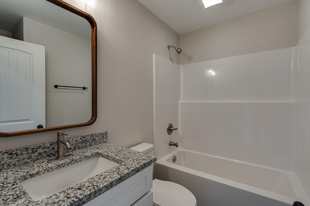 full bathroom featuring vanity, bathtub / shower combination, and toilet