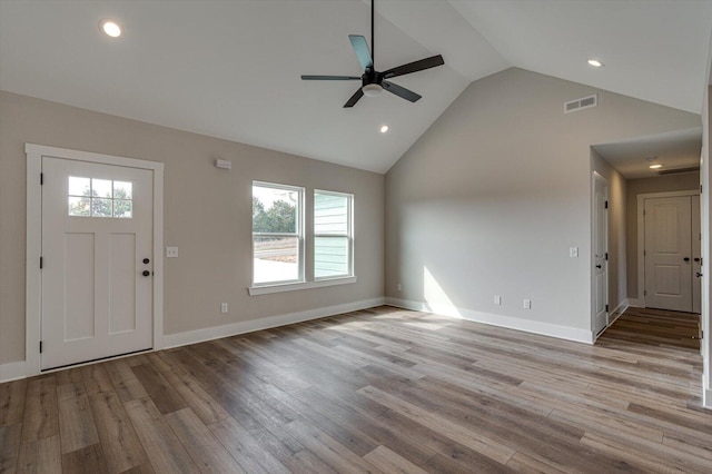 foyer entrance featuring ceiling fan, high vaulted ceiling, and light hardwood / wood-style flooring