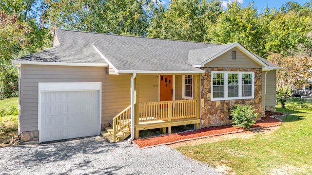 single story home with covered porch and a garage