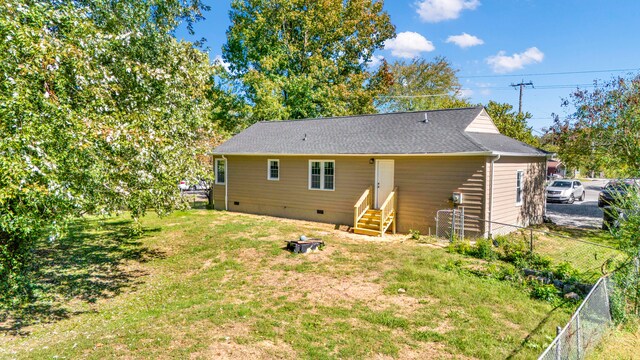 back of property featuring a lawn