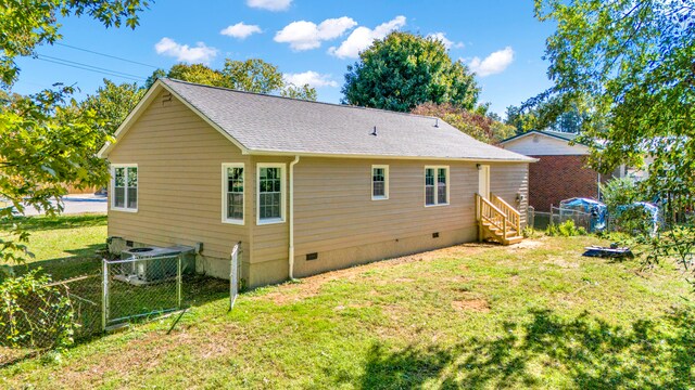 back of property featuring a lawn