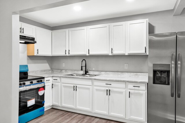 kitchen with sink, stainless steel refrigerator with ice dispenser, light hardwood / wood-style floors, white cabinets, and range