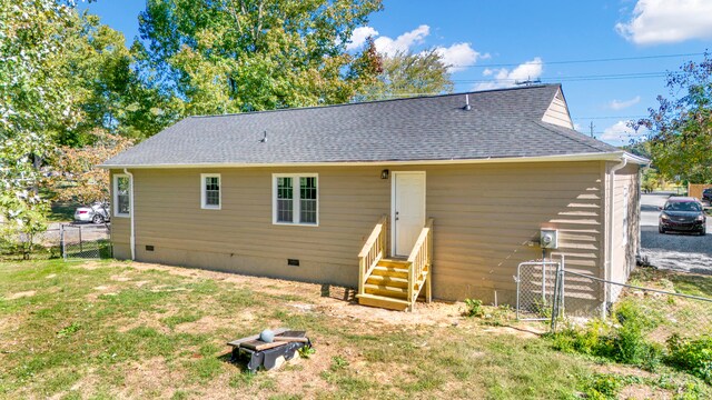 back of property featuring a lawn