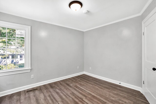 unfurnished room featuring crown molding and dark hardwood / wood-style flooring