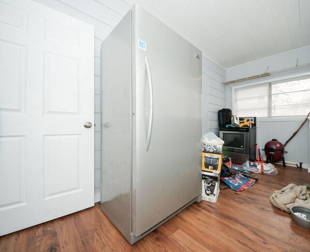 interior space featuring hardwood / wood-style floors and wooden walls