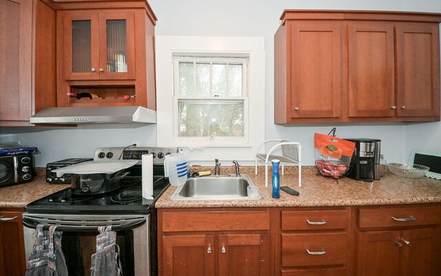 kitchen featuring extractor fan, black electric range oven, and sink