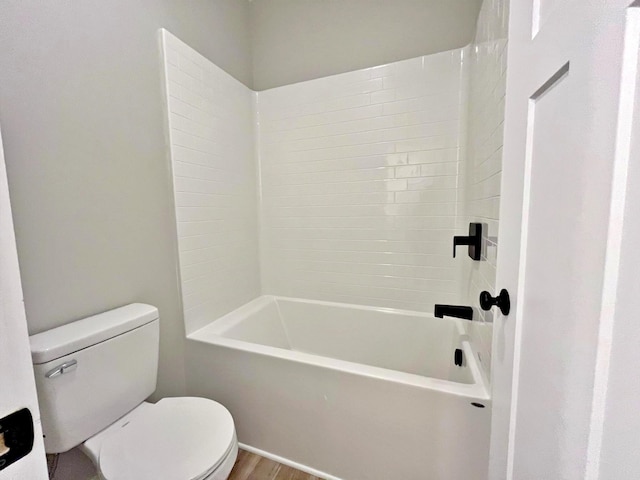 bathroom featuring shower / washtub combination, wood-type flooring, and toilet