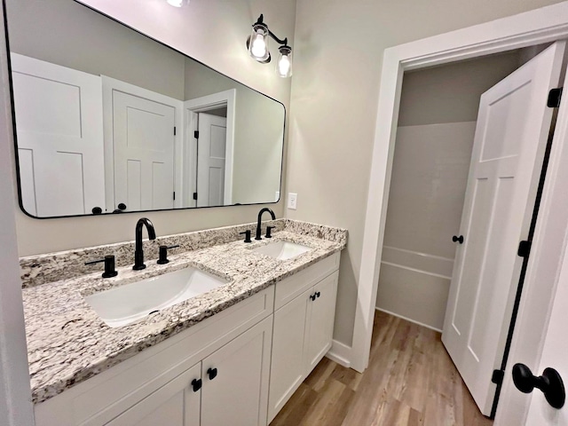 bathroom with hardwood / wood-style floors and vanity