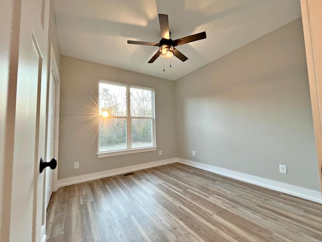 spare room featuring ceiling fan and light hardwood / wood-style floors