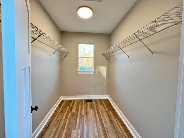 spacious closet featuring hardwood / wood-style flooring