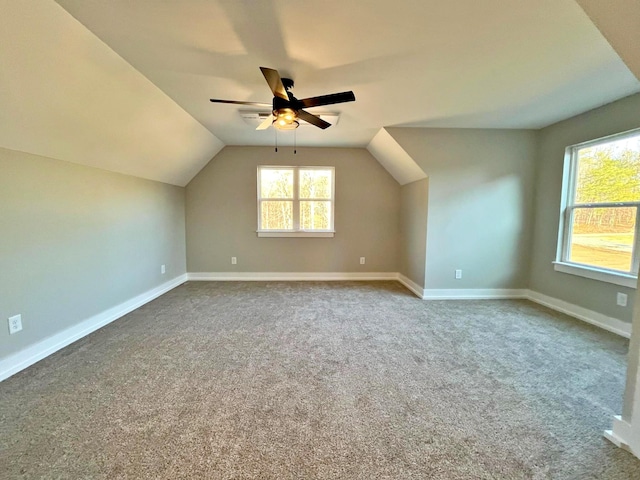 additional living space featuring carpet, ceiling fan, and vaulted ceiling