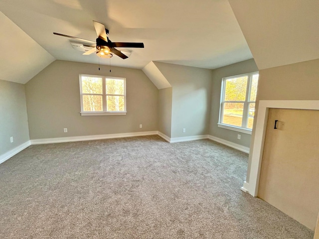 additional living space featuring ceiling fan, lofted ceiling, and carpet floors