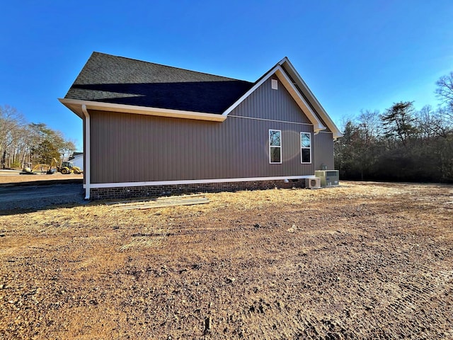 view of side of home featuring cooling unit