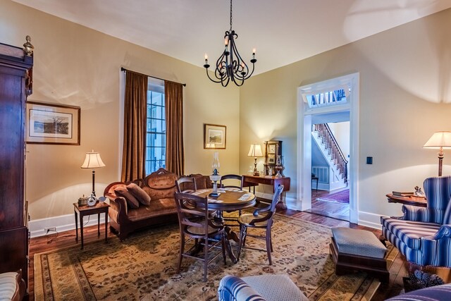 living room with hardwood / wood-style floors and an inviting chandelier