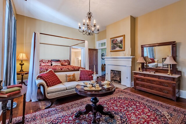 bedroom featuring wood-type flooring and a notable chandelier