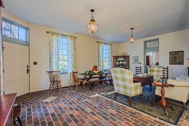 living room with a healthy amount of sunlight and a notable chandelier