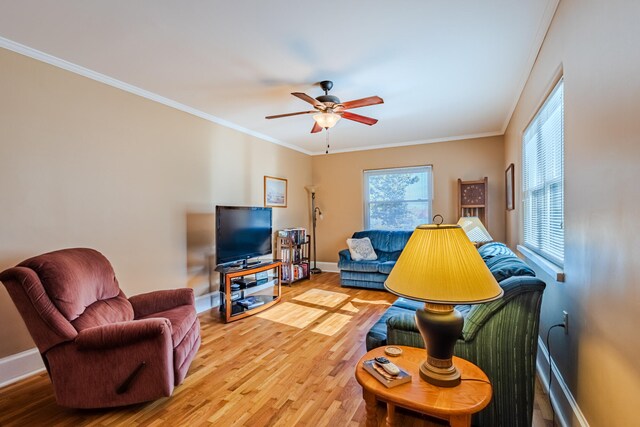 living room with hardwood / wood-style floors, ceiling fan, and crown molding