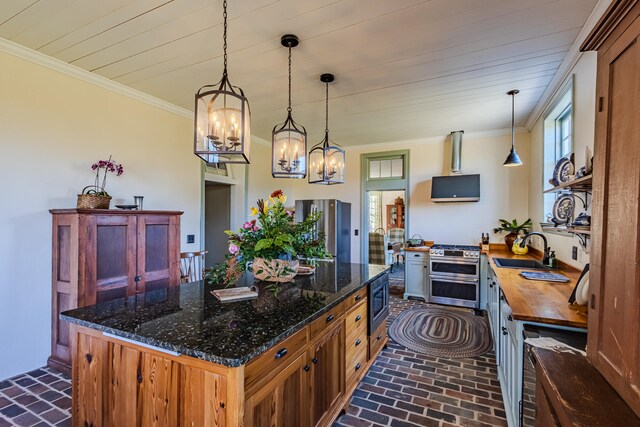 kitchen with pendant lighting, sink, dark stone countertops, a notable chandelier, and stainless steel appliances