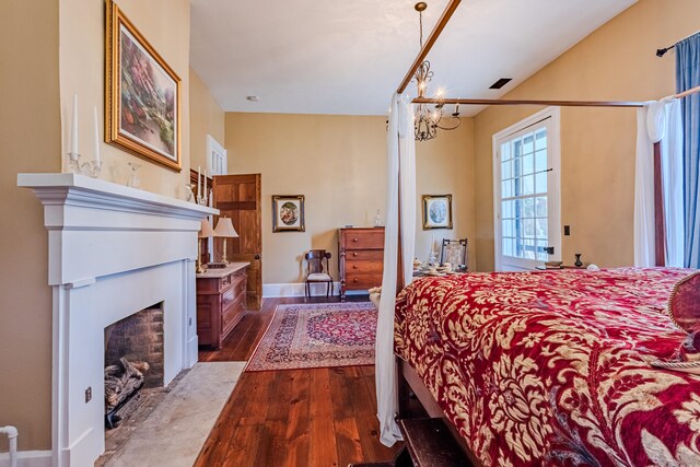 bedroom featuring wood-type flooring and a chandelier