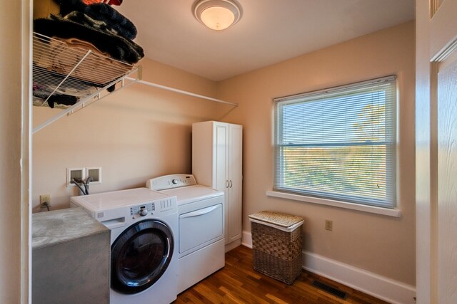 washroom with washer and dryer and dark hardwood / wood-style floors