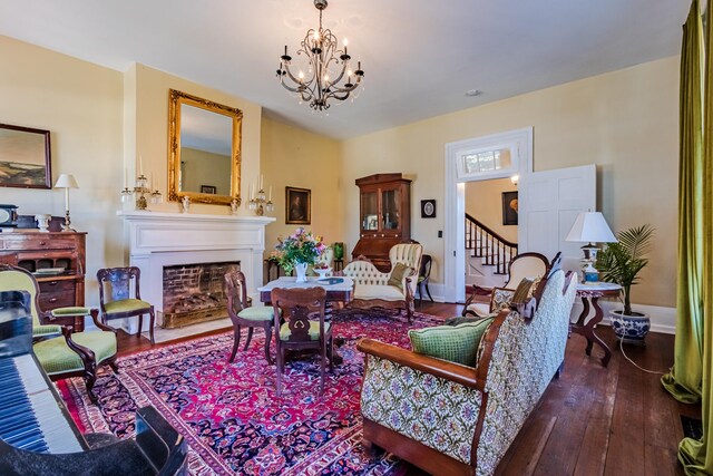 living room with dark hardwood / wood-style flooring and a chandelier