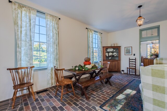 dining room featuring plenty of natural light and a notable chandelier