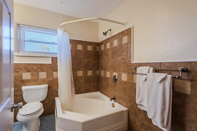 bathroom featuring tile patterned flooring, toilet, tile walls, and shower / tub combo