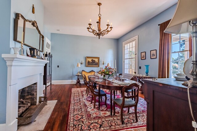 dining room with an inviting chandelier and dark wood-type flooring