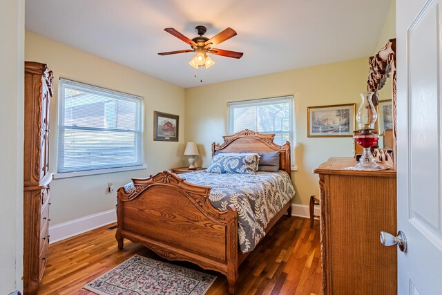 bedroom featuring ceiling fan and dark wood-type flooring