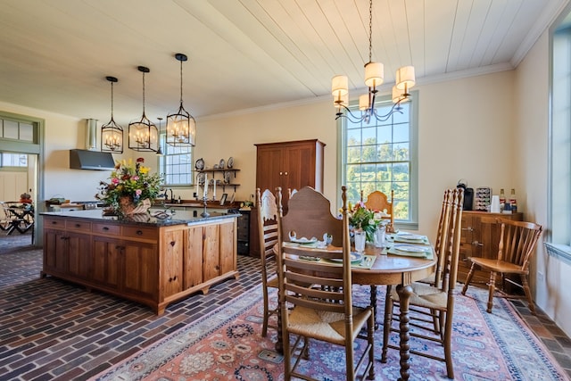 dining space featuring wood ceiling, crown molding, and a chandelier