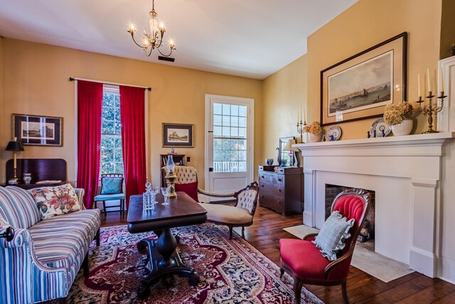 sitting room featuring dark hardwood / wood-style floors and a notable chandelier