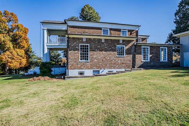 exterior space featuring a balcony and a lawn