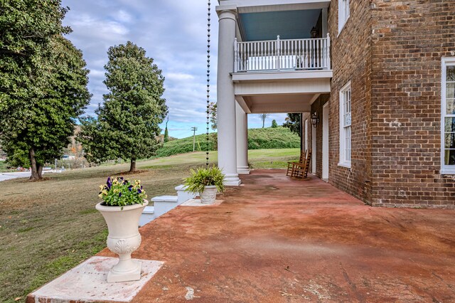 view of patio featuring a balcony