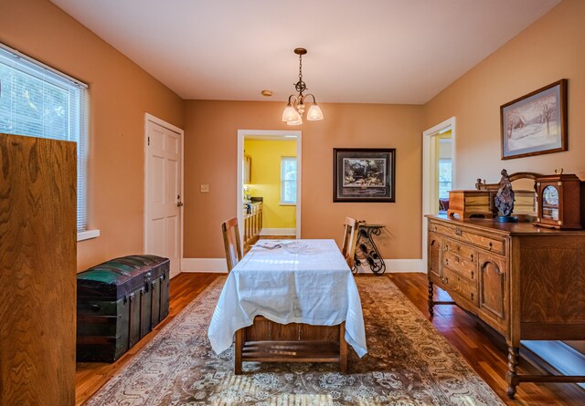 bedroom featuring a notable chandelier and dark hardwood / wood-style floors