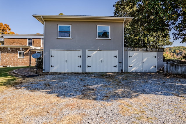 rear view of house featuring a garage