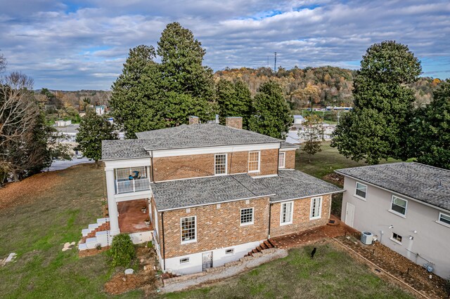 back of house featuring a balcony