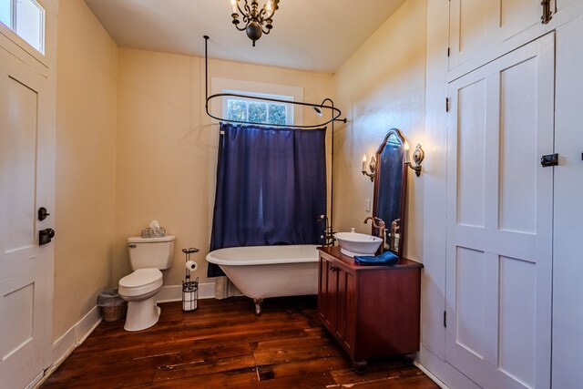 full bathroom with separate shower and tub, vanity, wood-type flooring, and toilet