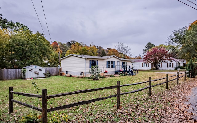 view of front facade featuring a front yard and a storage unit