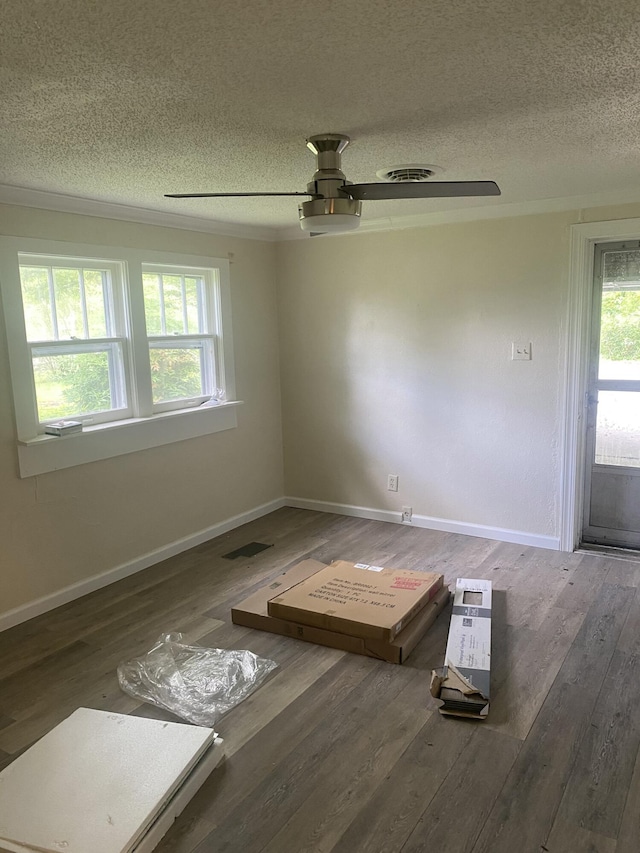 2320 Raines Dr NW, Cleveland, TN 37311 - unfurnished room featuring a textured ceiling, plenty of natural light, wood finished floors, and ceiling fan