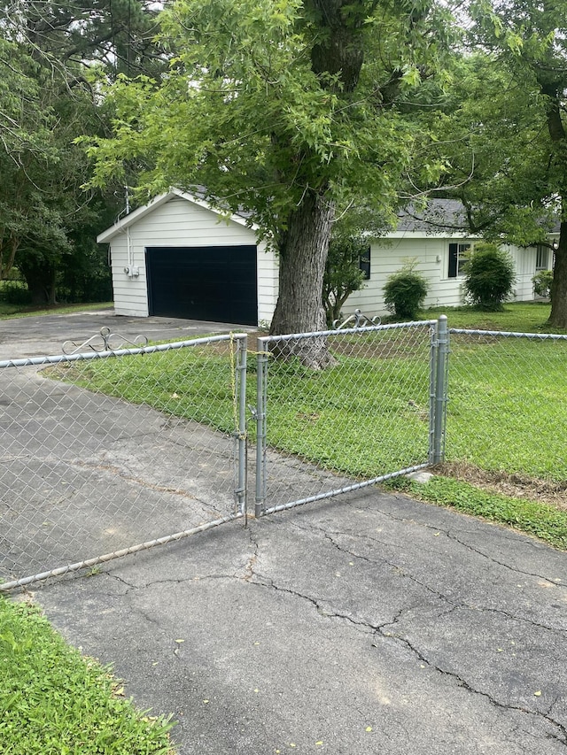 2320 Raines Dr NW, Cleveland, TN 37311 - ranch-style house featuring an outbuilding, a gate, driveway, and a garage