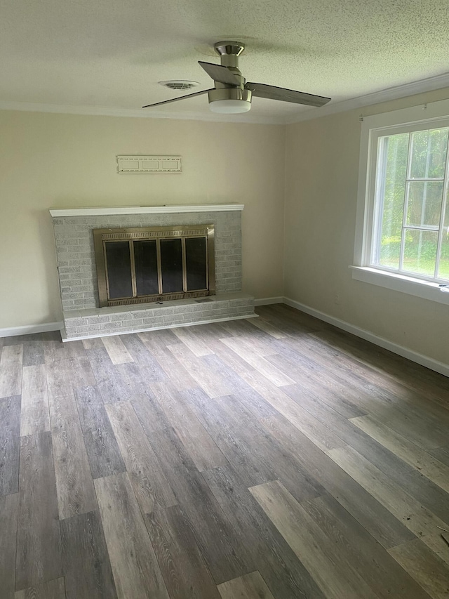 2320 Raines Dr NW, Cleveland, TN 37311 - unfurnished living room with a brick fireplace, a ceiling fan, wood finished floors, and a textured ceiling