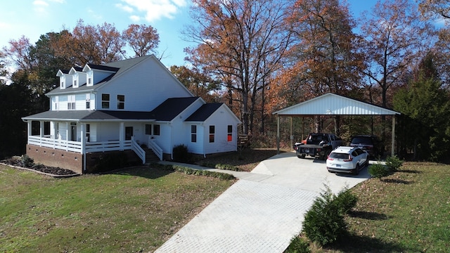 view of front of property with a porch, a front yard, and a carport