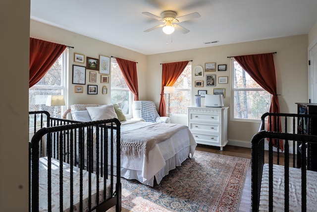 bedroom with ceiling fan and dark wood-type flooring