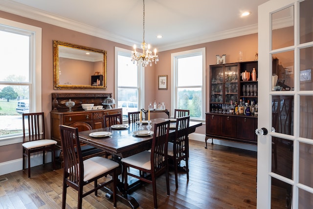 dining room featuring a notable chandelier, dark hardwood / wood-style flooring, and crown molding