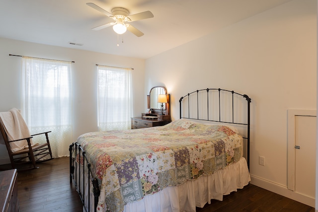 bedroom with dark hardwood / wood-style floors and ceiling fan