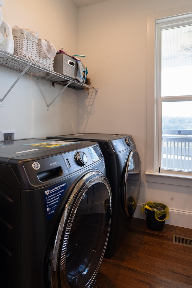 washroom featuring dark hardwood / wood-style flooring and independent washer and dryer