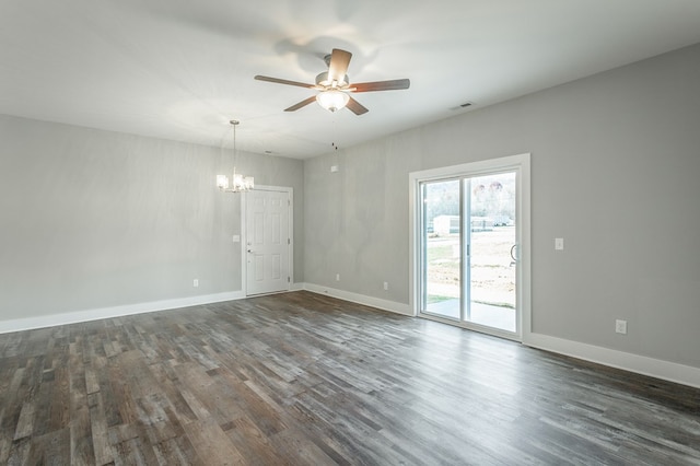 unfurnished room featuring ceiling fan with notable chandelier and dark hardwood / wood-style floors