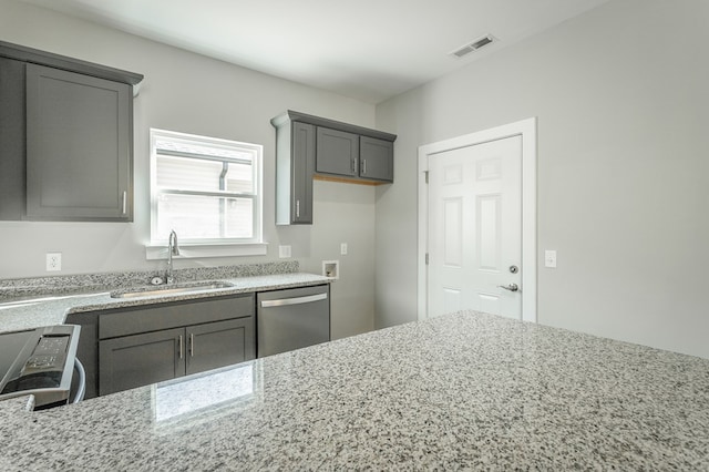 kitchen featuring gray cabinets, light stone counters, sink, and stainless steel appliances