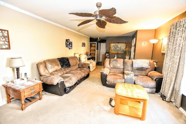 living room with ceiling fan, carpet, and ornamental molding