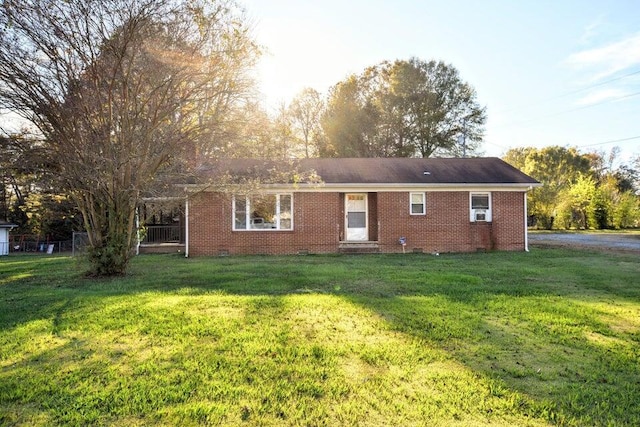 rear view of property featuring a yard